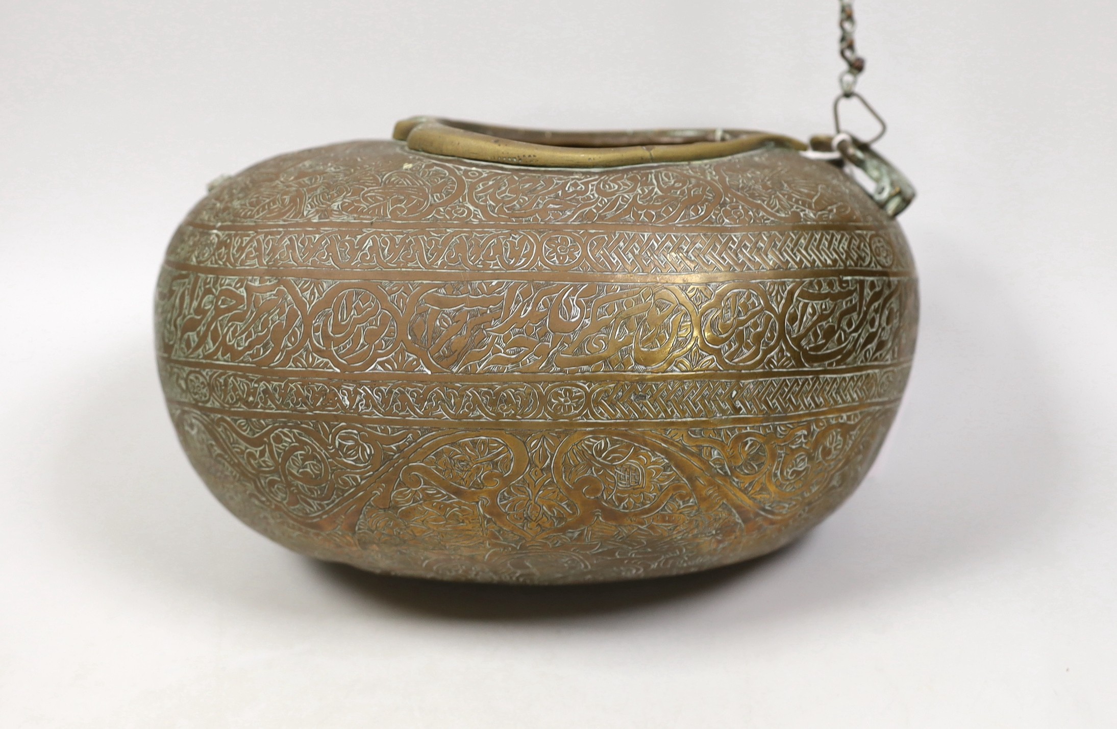 A 19th century Persian engraved brass kashkul, Qajar dynasty, 16cm wide and a bronze kettle, 17cm tall